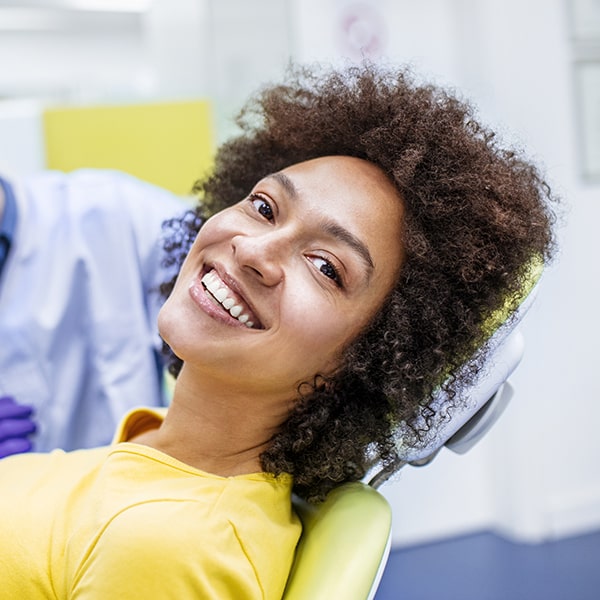 A woman at the dentist sitting in the chair