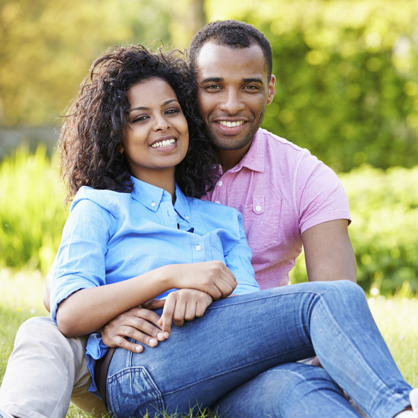 A couple hugging and smiling outside